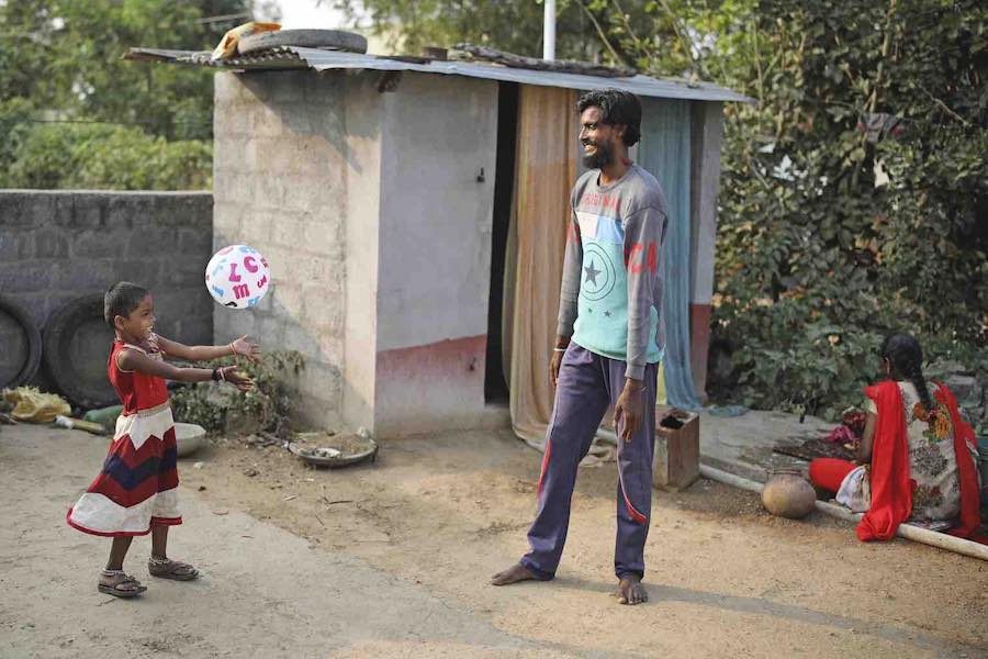 Un padre juega con su hija al fútbol en India