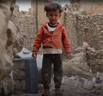Un niño jugando sobre escombros