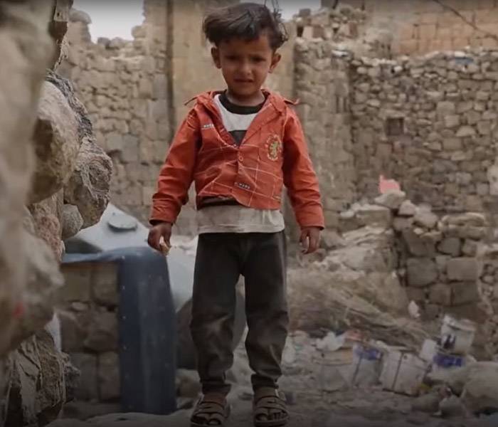 Un niño jugando sobre escombros