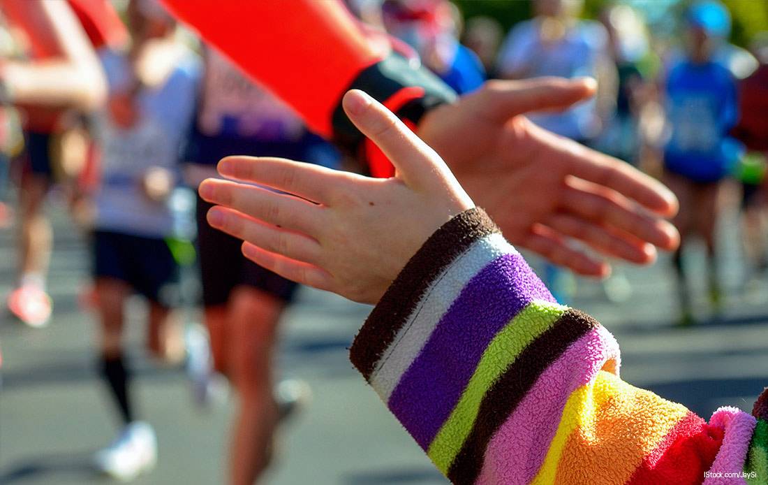 Dos participantes de una carrera chocan sus manos